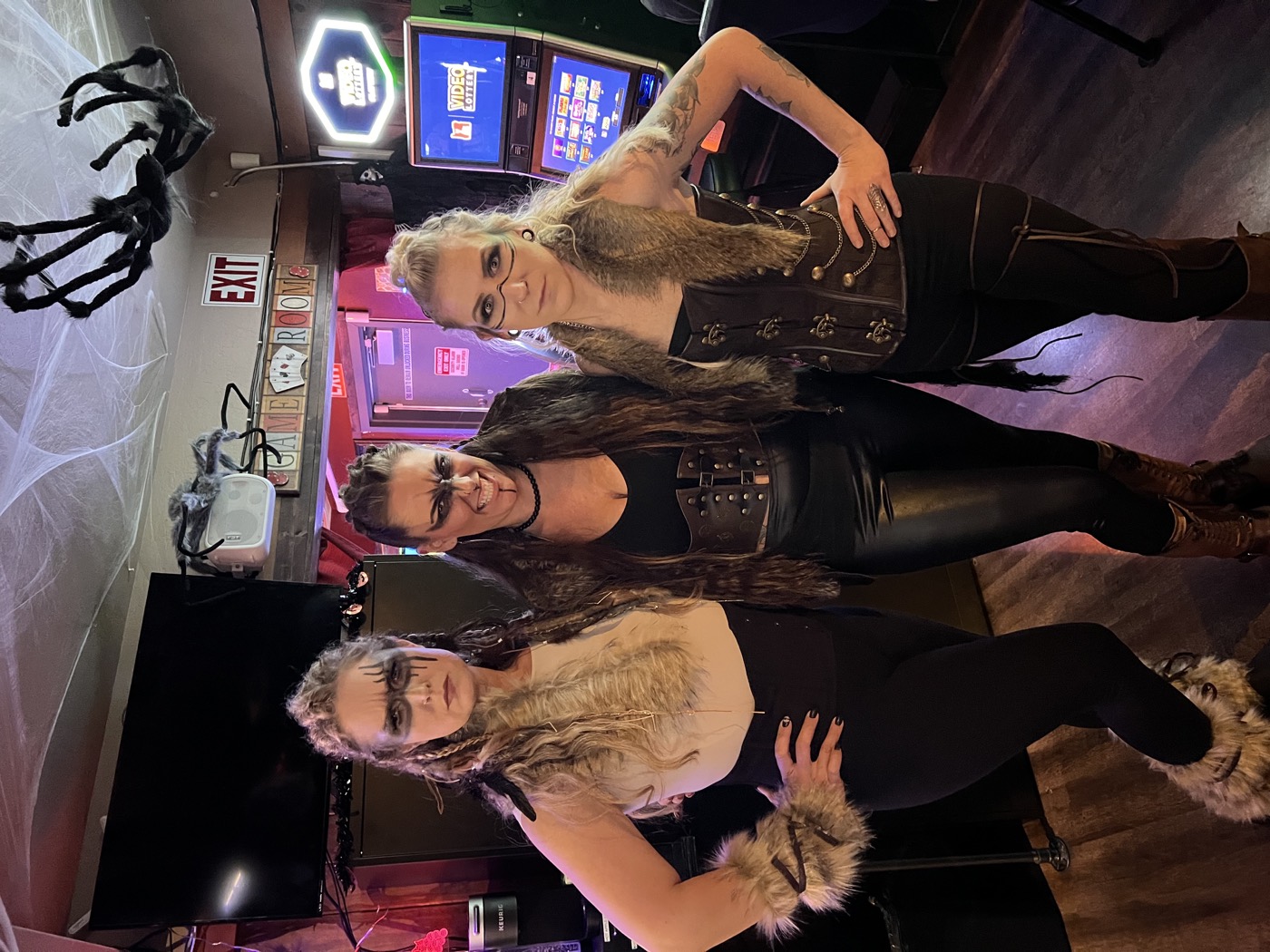 Three guests dressed for a costume night at Flespy’s