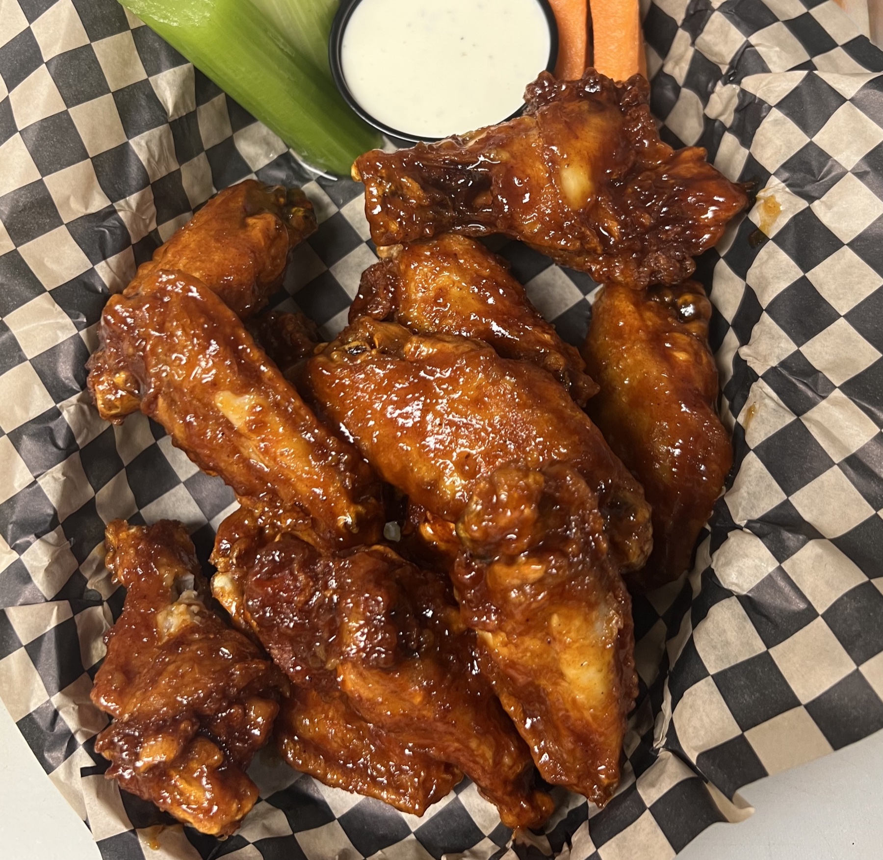 Six sauced chicken wings with carrots, celery, and dipping sauce